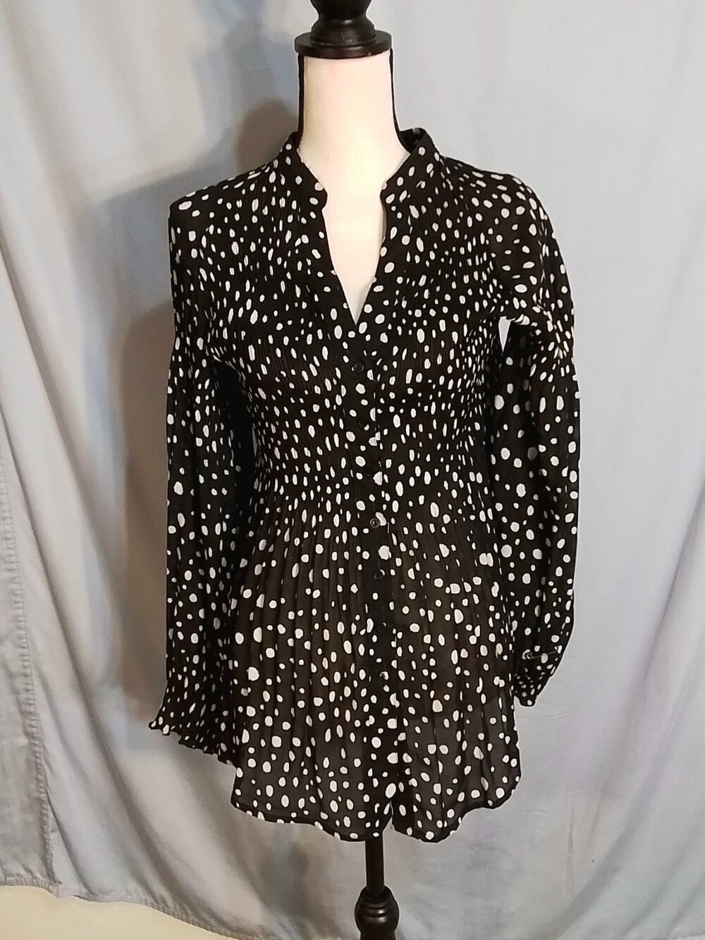 Hayley Matthews accordion style black blouse with white dots